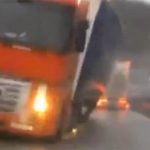 VIDEO: Trucks almost crush car in storm
