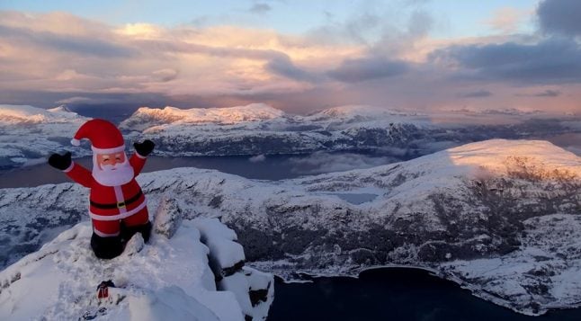 Norwegians take six-metre inflatable Santa to top of Europe’s highest sea cliff